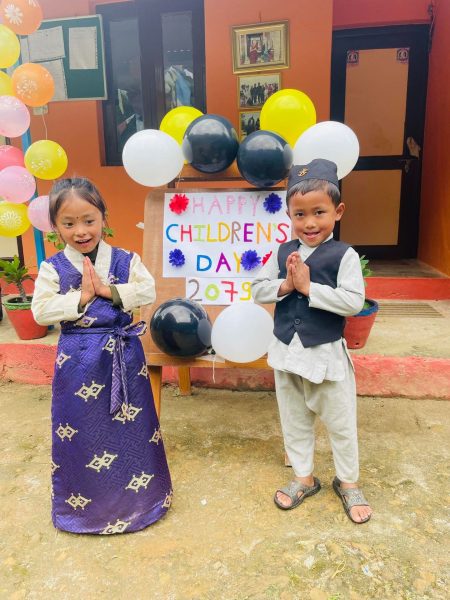 two children next to a happy children's day sign