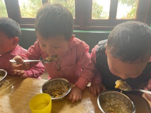 Nursery children enjoying lunch