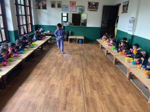 The whole nursery class having lunch together