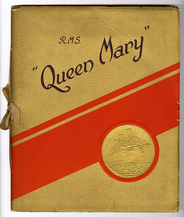 A colour photo of the gold and red R.M.S. Queen Mary souvenir brochure cover
