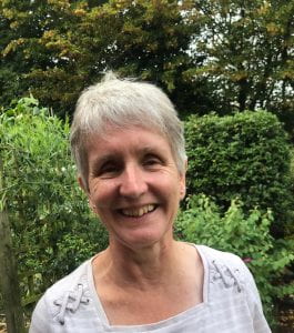 a smiling photo of Eileen who has short grey hair