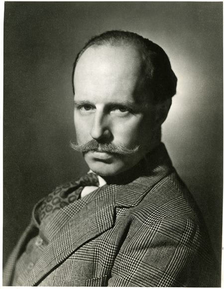 Black and white portrait of Basil Spence sporting a tweed suit and a moustache