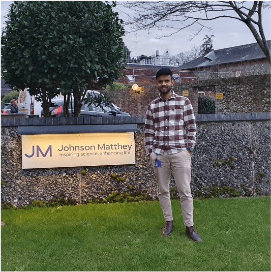Syeed standing in front of Johnson Matthey company sign