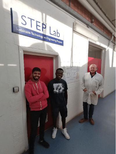 Three students standing outside engineering lab