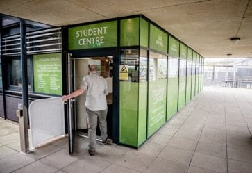 Person walking in to the University of Brighton Student Centre