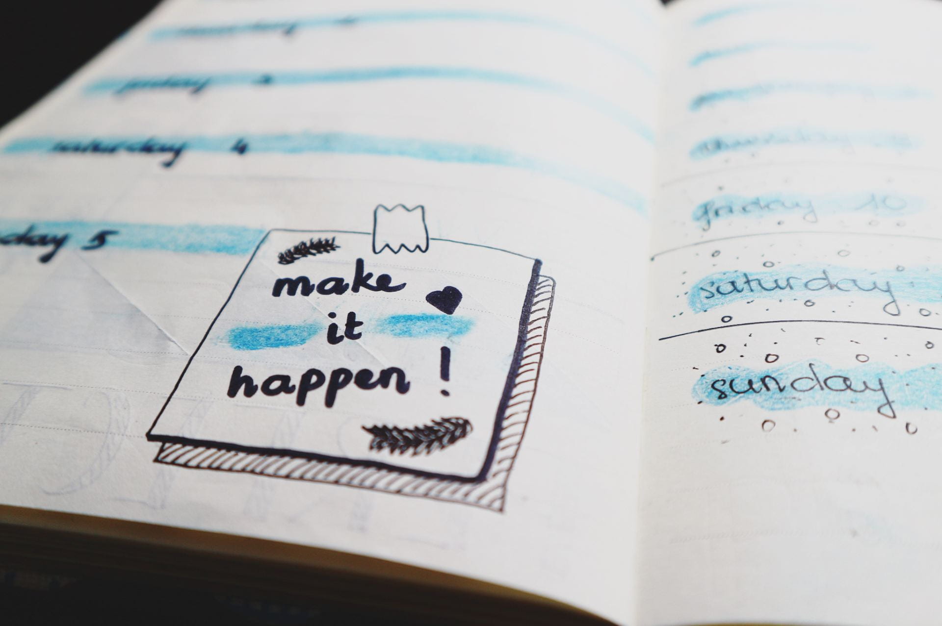 Notebook with the words make it happen highlighted