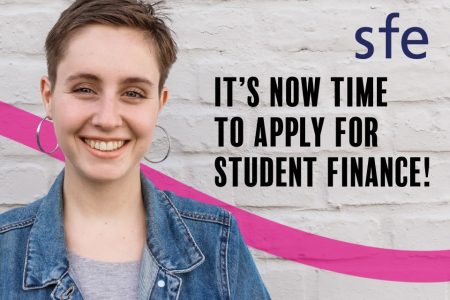 Person standing in front of a wall with Its now time apply for student finance written on it
