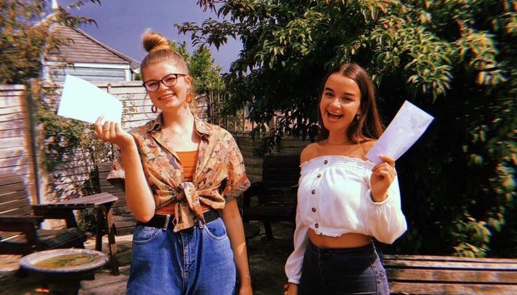 Jenny and a friend holding their results