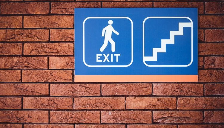 Building sign showing fire exit on stairs