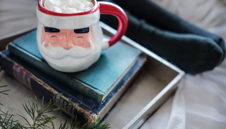 Santa mug and books by Drew Coffman (Unsplash)
