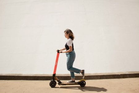 Young woman riding a scooter