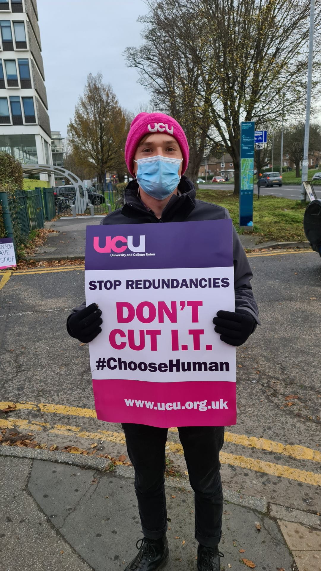 Student on picket line holding 'Don't Cut IT' placard