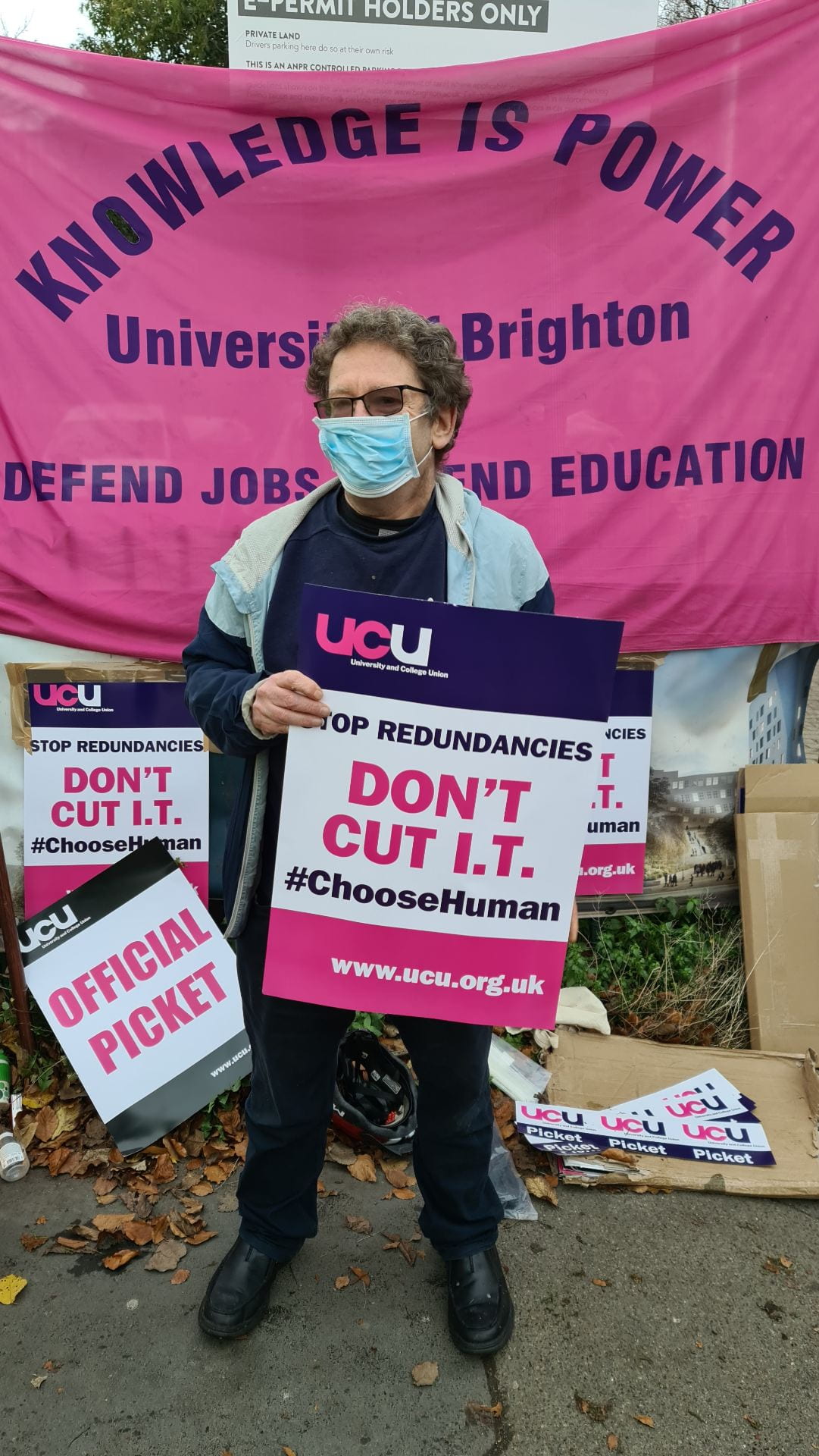 Staff on picket line holding 'Don't Cut IT' placard