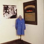 A colour photograph from the Women Designing: Redefining Design in Britain Between the Wars exhibition showing wall hangings and a display jacket